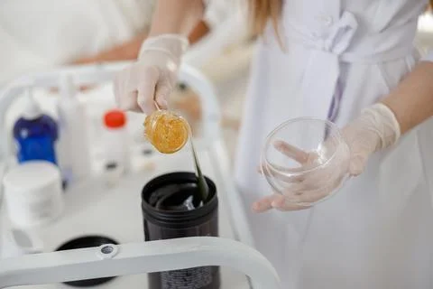 Close up take sugar paste from can in wax. Concept of medicine, medical Stock Photos