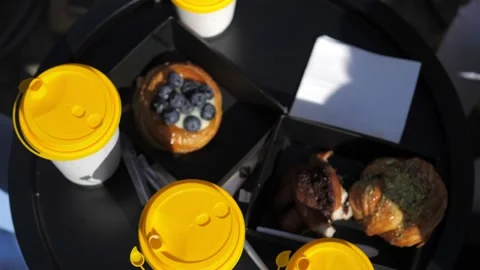 Close up of takeaway coffee cups standing on the black table in the summer Stock Footage 219944476