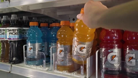 Close up taking and putting back energy drink from refrigerator shelf 库存影片 156247810