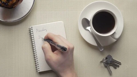 Close-up of taking notes in a notebook in the morning Stock Footage 75458607