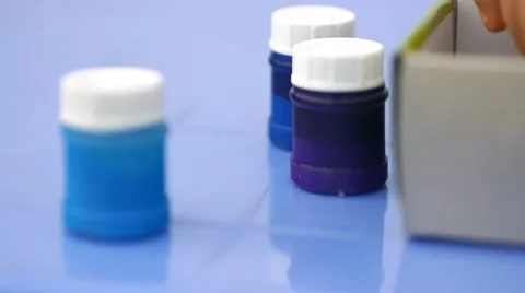 Close up of  taking out of the box jars of colorful paint Stock Footage 50265446