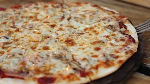 Close up taking slice of homemade pizza with stretching cheese Video stock 120785312