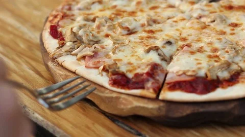 Close up taking slice of homemade pizza with stretching cheese Video stock 120785323