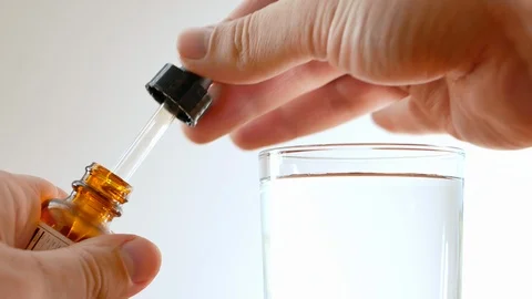 Close-up of taking small amount of medicine drugs from little bottle pipette Stockbeeldmateriaal 116617184