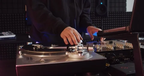 Close-up of talented young man mixing tracks turning knobs on modern mixer Video stock 114337739