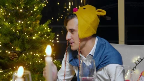 Close-up of a talking guy for New Years. Friends celebrate the New Year at the Video stock 167244793