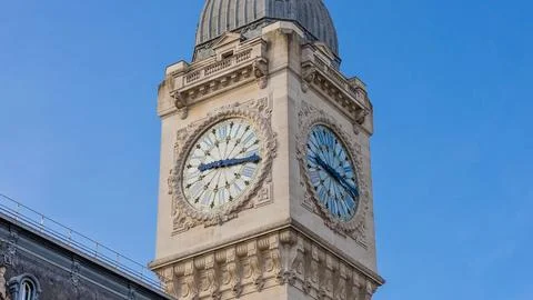 Close up of a tall ornate clock tower against a clear blue sky Stock Photos