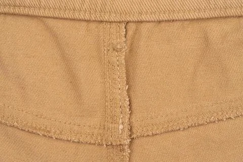 Close up of tan fabric texture with visible stitching and seam detail Photos