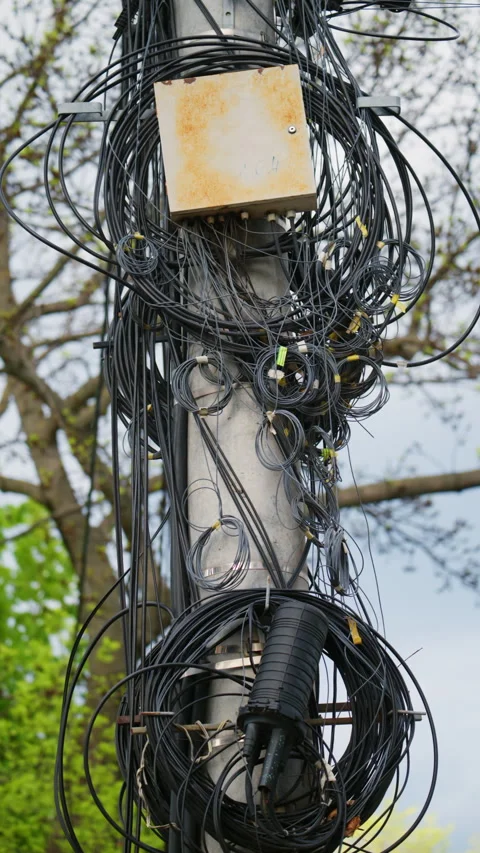 Close up of tangled cables and wires on a utility pole Stock Footage 335397472
