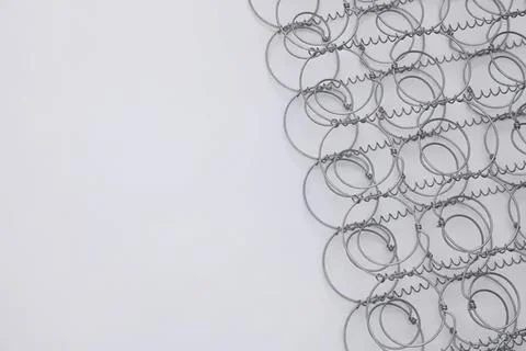 Close-up of tangled wire loops on light gray background Stock Photos