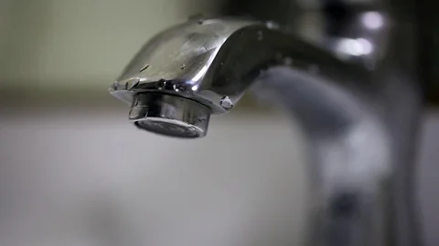 Close up of a tap being turned on and turned off Stock Footage 74759017