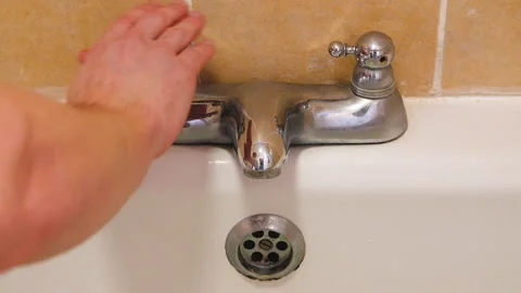 Close up of tap being turned on for bath. By caucasian hand. Stock Footage 160418324