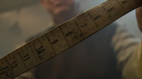A Close-up of a tape measure being held by a man Stock Footage 311924099