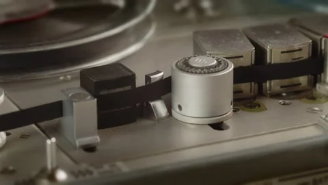 Close up of tape rolling in Nagra old professional tape recorder. Detail Stock Footage 160119754