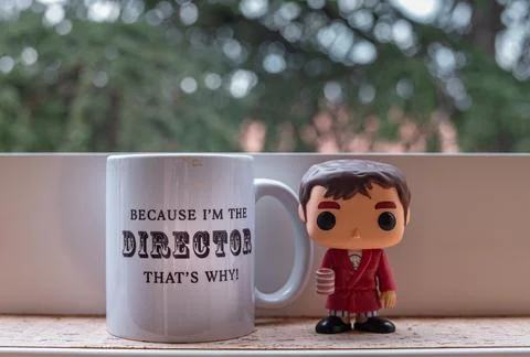 Close-up of a Tarantino figurine next to a mug with a funny message on a terrace Stock Photos