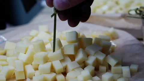 Close-up of tasting diced cheese. Stock Footage 153309025