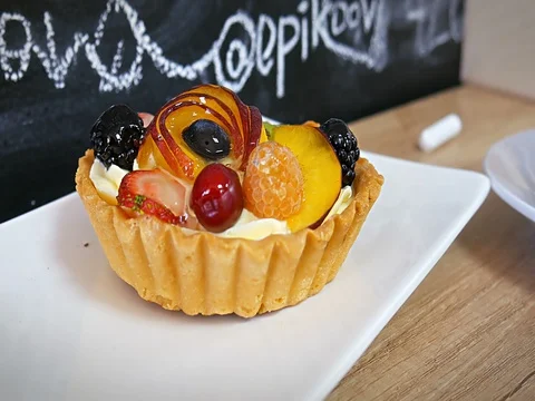 Close up tasting fruit tart with fork in coffee bar Stock Footage 81336281