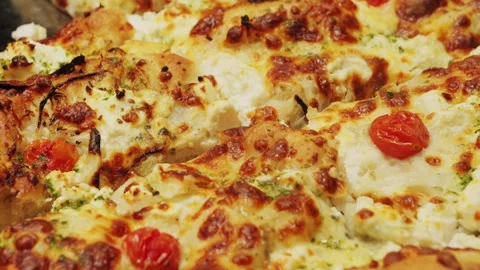 Close-up of a tasty fresh pizza, capturing the melted goodness and rich texture Stock Footage 314557419