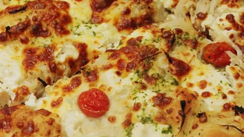 Close-up of a tasty fresh pizza, capturing the melted goodness and rich texture Stock Footage 314557540