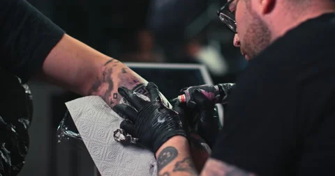 Close up tattoo artist shows the process of getting tattoos with paint. Stock Footage 236328516