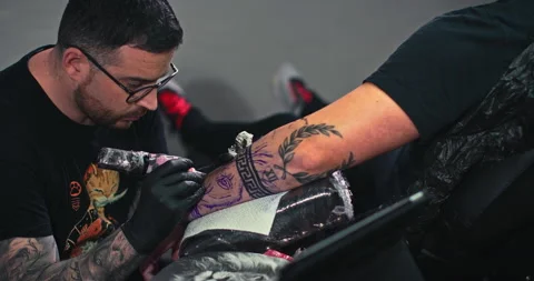 Close up tattoo artist shows the process of getting tattoos with paint. Stock Footage 236328648