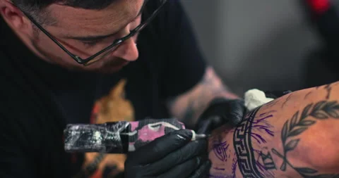 Close up tattoo artist shows the process of getting tattoos with paint. Stock Footage 236329310