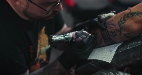Close up tattoo artist shows the process of getting tattoos with paint. Stock Footage 236329853
