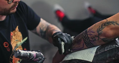 Close up tattoo artist shows the process of getting tattoos with paint. Stock Footage 236329882