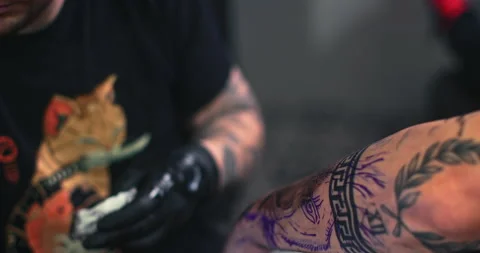 Close up tattoo artist shows the process of getting tattoos with paint. Stock Footage 236329933