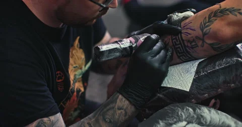 Close up tattoo artist shows the process of getting tattoos with paint. Stock Footage 236330309