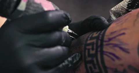 Close up tattoo artist shows the process of getting tattoos with paint. Stock Footage 236331252