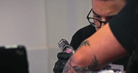 Close up tattoo artist shows the process of getting tattoos with paint. Stock Footage 236331839