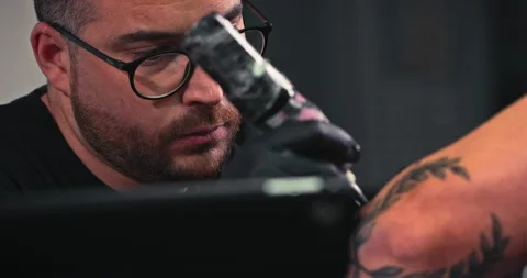 Close up tattoo artist shows the process of getting tattoos with paint. Stock Footage 236332022