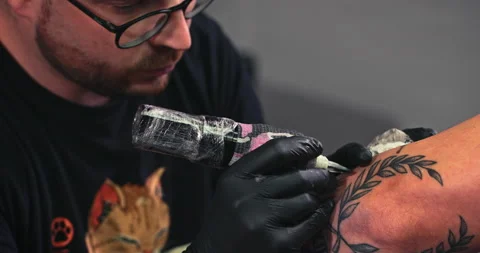 Close up tattoo artist shows the process of getting tattoos with paint. Stock Footage 236332177