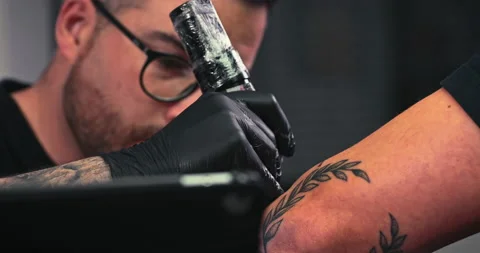 Close up tattoo artist shows the process of getting tattoos with paint. Stock Footage 236332210