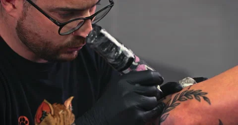 Close up tattoo artist shows the process of getting tattoos with paint. Stock Footage 236332233