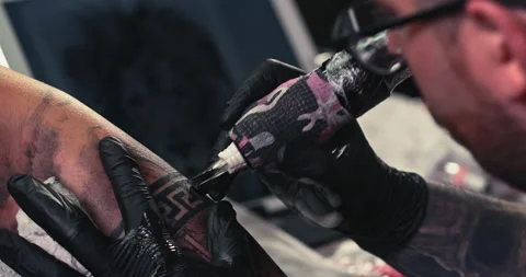 Close up tattoo artist shows the process of getting tattoos with paint. Stock Footage 236332743