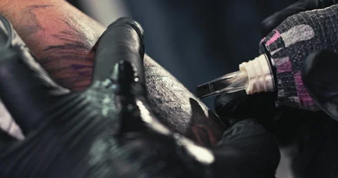 Close up tattoo artist shows the process of getting tattoos with paint. Stock Footage 236333009