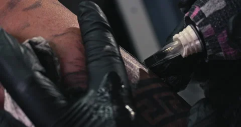 Close up tattoo artist shows the process of getting tattoos with paint. Stock Footage 236333094