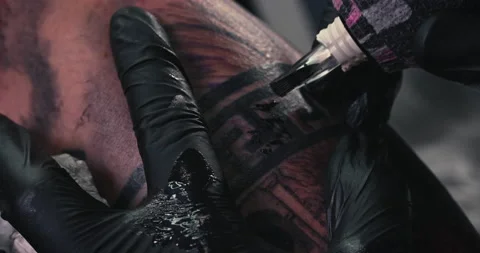 Close up tattoo artist shows the process of getting tattoos with paint. Stock Footage 236333134