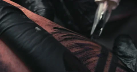 Close up tattoo artist shows the process of getting tattoos with paint. Stock Footage 236333432
