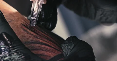 Close up tattoo artist shows the process of getting tattoos with paint. Stock Footage 236333773
