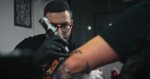Close up tattoo artist shows the process of getting tattoos with paint. Stock Footage 236333801