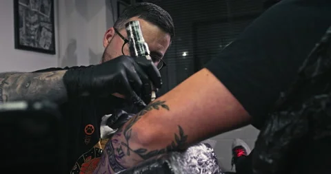 Close up tattoo artist shows the process of getting tattoos with paint. Stock Footage 236334123