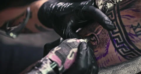 Close up tattoo artist shows the process of getting tattoos with paint. Stock Footage 236336525