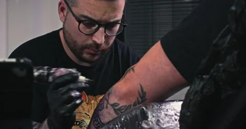 Close up tattoo artist shows the process of getting tattoos with paint. Stock Footage 236338005