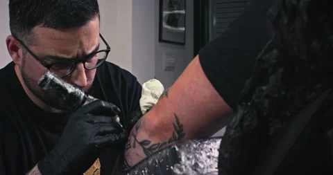 Close up tattoo artist shows the process of getting tattoos with paint. Stock Footage 236338019