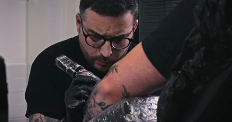 Close up tattoo artist shows the process of getting tattoos with paint. Stock Footage 236338723