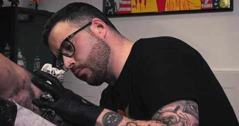Close up tattoo artist shows the process of getting tattoos with paint. Stock Footage 236338810