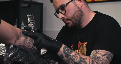 Close up tattoo artist shows the process of getting tattoos with paint. Stock Footage 236339074